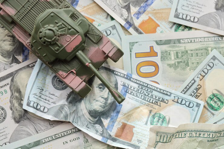 Tank on crumpled hundred dollar bills banknotes background of war funding and military support
