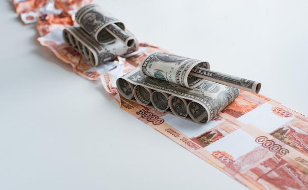 Tank made of dollar bills rides on a road made of ruble bills