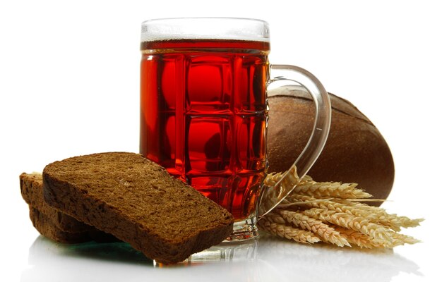 Tankard of kvass and rye breads with ears, isolated on white