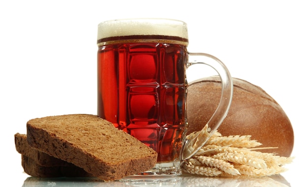 Tankard of kvass and rye breads with ears isolated on white