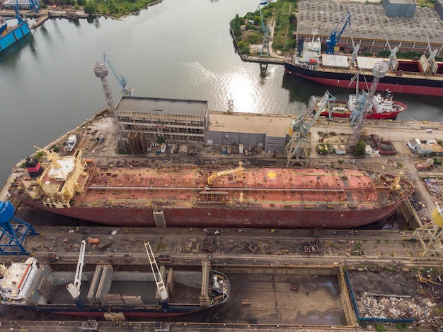 Tanker vessel repair in dry dock Shipyard aerial view