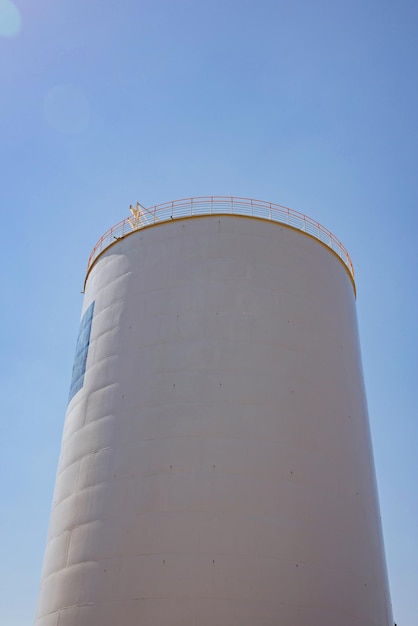 Tanks industrial architecture fragment on blue sky background