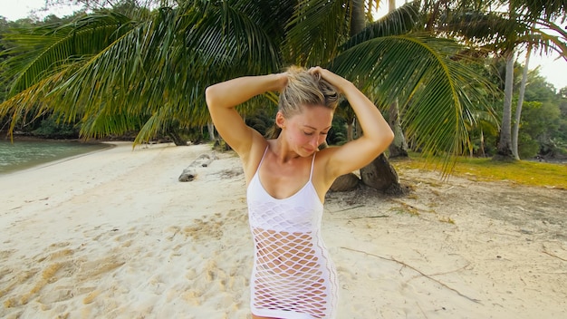 The tanned woman dances cool and appetizing on the beach of Koh Chang island in Thailand Booty dancing twerk Concept travel walks rest in sea tropical resort traveling tourism summer holidays