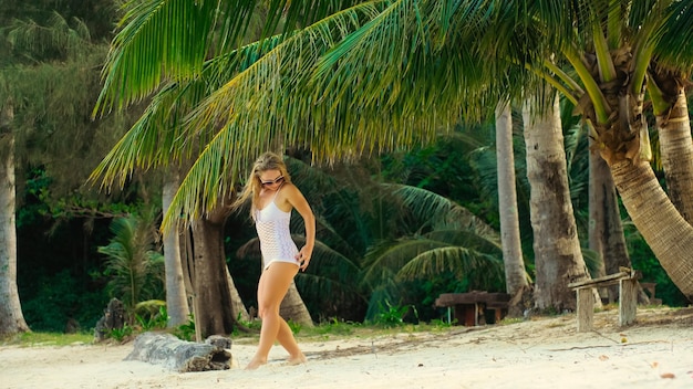 The tanned woman dances cool and appetizing on the beach of Koh Chang island in Thailand Booty dancing twerk Concept travel walks rest in sea tropical resort traveling tourism summer holidays