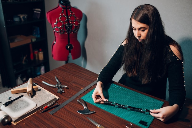 Tanner woman making leather goods on workshop Working process of leather craftsman