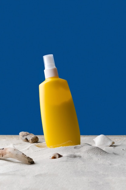 Tanning agent in the sand The concept of protecting the skin from the sun's rays Cream lotion spray