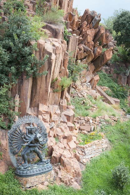 Tantric Deities statue in Ritual Embrace located in a mountain garden