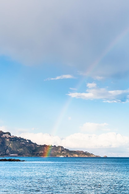 Taormina cape and rainbow in Ionian Sea in spring