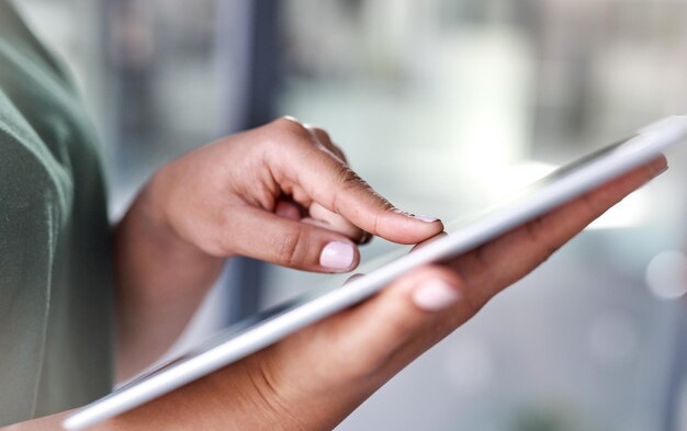 Tap in to a broader world shot of an unrecognisable woman using a digital tablet