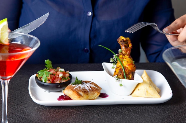 Photo tapas plate of bastilla, fried chicken leg, salad