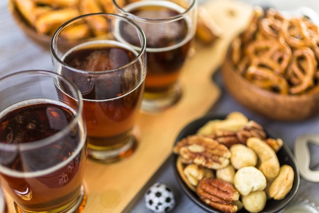 Tapbier en zoute snacks op tafel voor een voetbalfeest.