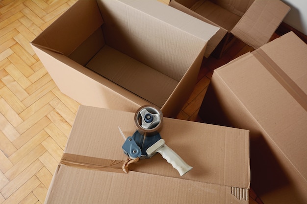 Tape dispenser sealing a shipping cardboard box