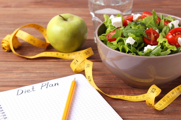 Photo tape and lettuce on a light background slimming diet healthy food