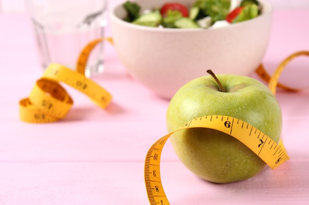 Tape and lettuce on a light background slimming diet healthy food