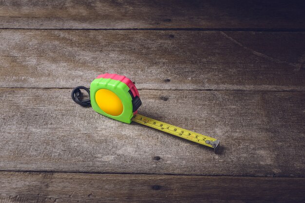 Photo tape measure on the brown wooden background