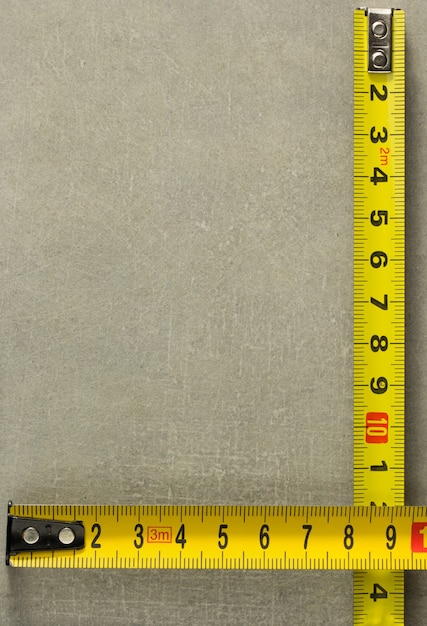 Tape measure at old background texture