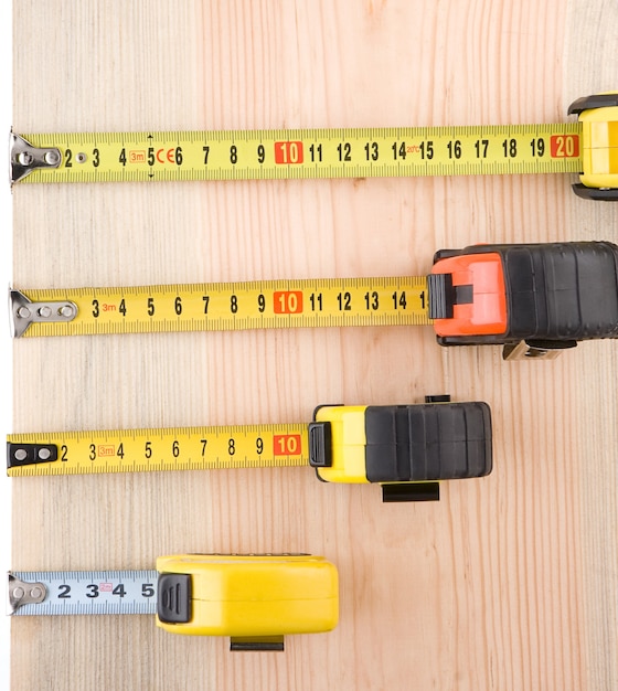 Tape measure on wood brick solated at white