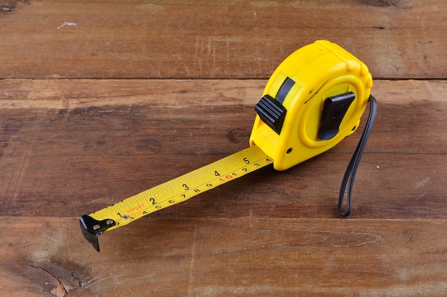 Photo tape measure on the wooden background