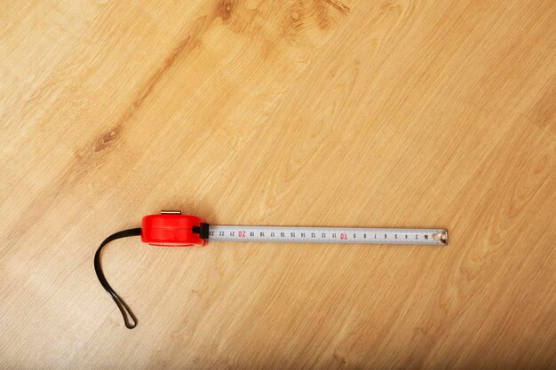 Tape measure on wooden floor