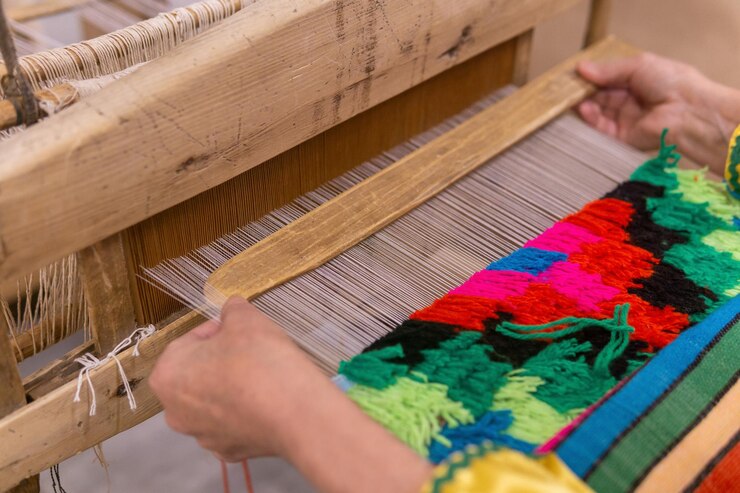 Photo tapestry weaving process on a traditional wooden handloom