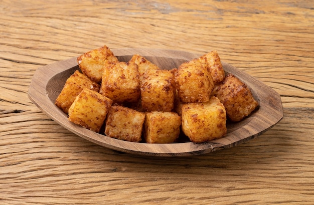 Tapioca dice typical northeast brazilian food over wooden table