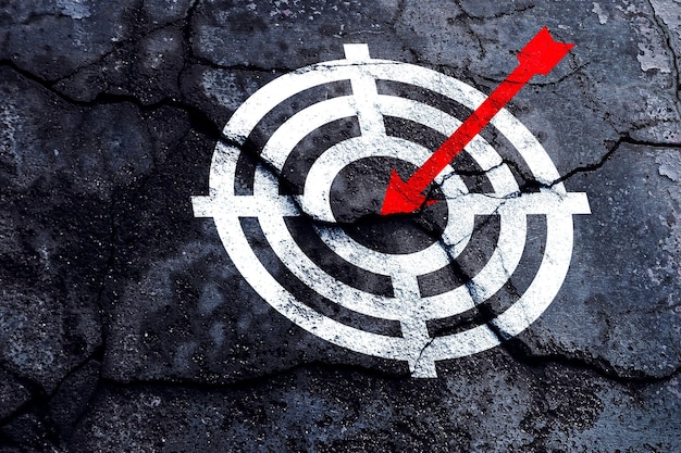 Target figure on broken wall concept of achieving goal quality Aim Target Red Symbols of goals and objectives over grunge background business idea