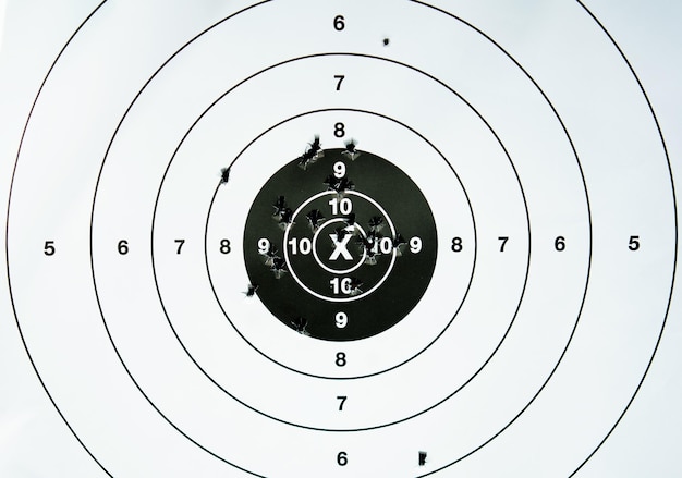 Photo target shooting practice with bullet holes closeup