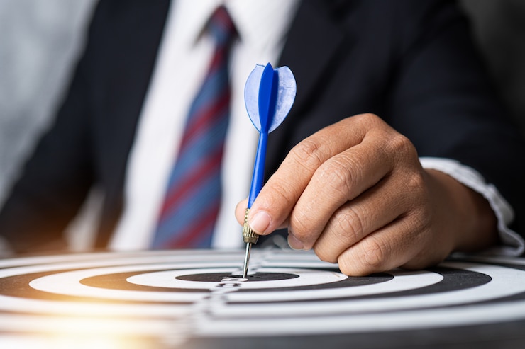 Photo target and strategy concept, businessman focus to aim by throwing dart on targeting	