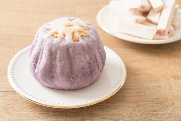 taro bun with white sugar cream and nut on top