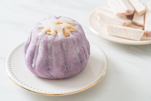 taro bun with white sugar cream and nut on top