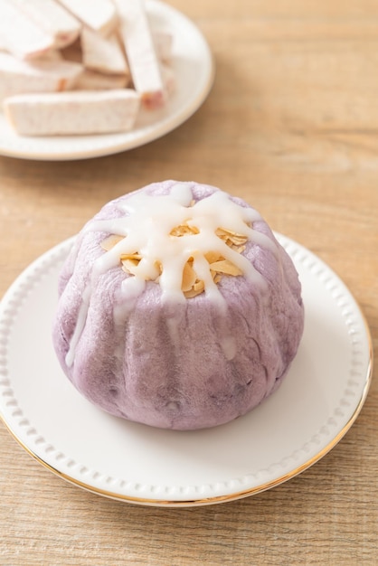 taro bun with white sugar cream and nut on top