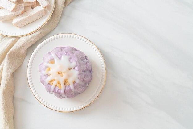 taro bun with white sugar cream and nut on top