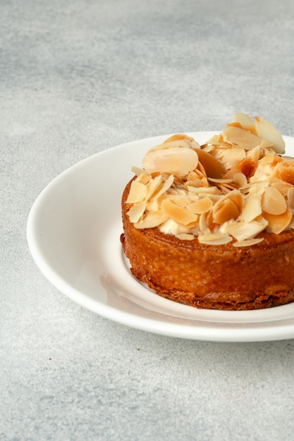 Tart pie with almond petals on plate