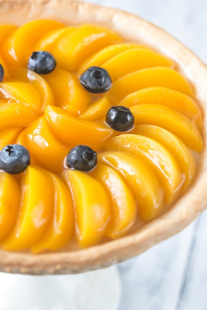 Tart with peaches and blueberry