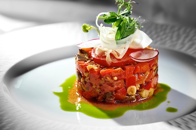 Tartare made of roasted peppers tomatoes and sauce in a plate Vegetarian food