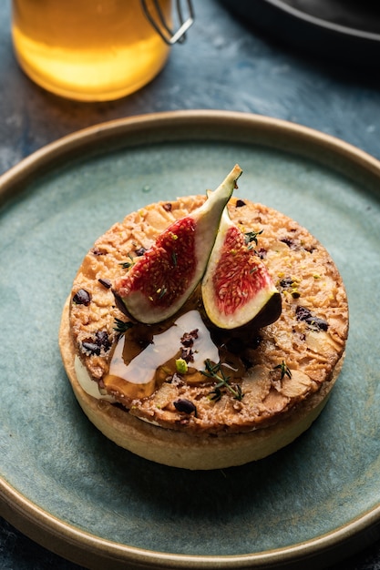 Tarte on sand base with fresh figs, almonds and crispy waffle with almonds and cocoa powder. Fresh Homemade Fruit Tart with berries