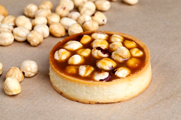 Tartlet cake with soft creamy caramel and roasted hazelnuts, delicious salted caramel cake with hazelnuts