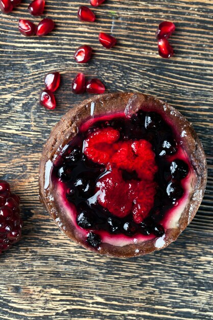 Tartlet with berry filling on the kitchen table, closeup