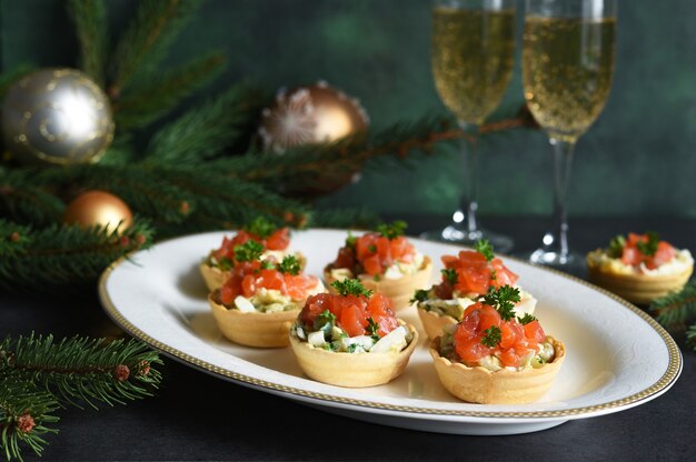 Tartlets stuffed with salad and salmon on a New Year's table