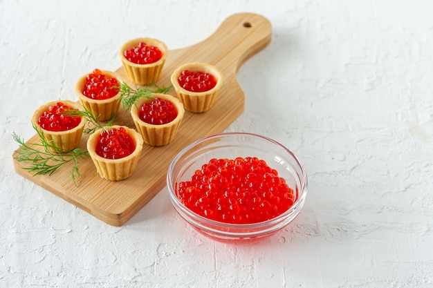 Tartlets with butter and red caviar. Gourmet food, appetizer. Delicatessen. Seafood.