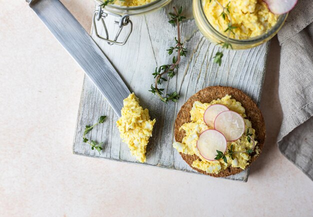 Tartlets with egg pate or salad and radish and thyme Egg dip in glass jar