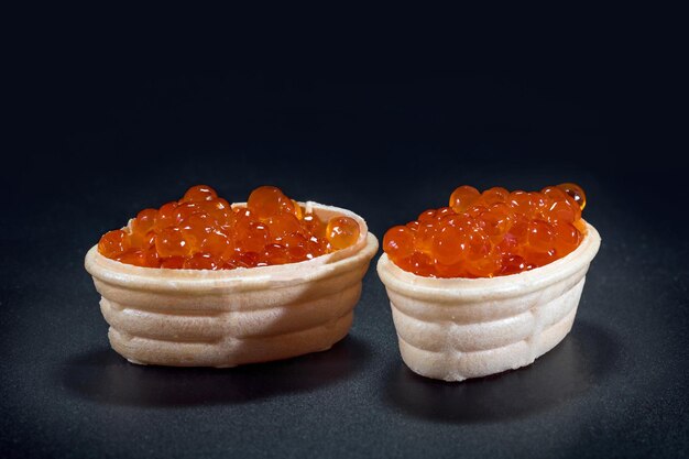 Tartlets with red caviar close up Snacks with red caviar appetizer