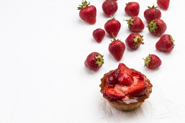 Tarts with berries. Strawberry on white background. Top view.  Copy space.