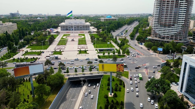 Tashkent Uzbekistan May 24 2021 Aerial view of International Friendship Square in Tashkent city with waving Uzbekistan flag