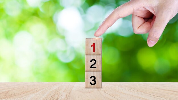 task priority and management concept the order of priority in any activity set work priority arrange to do list hand arranging wooden cube blocks with number first second third