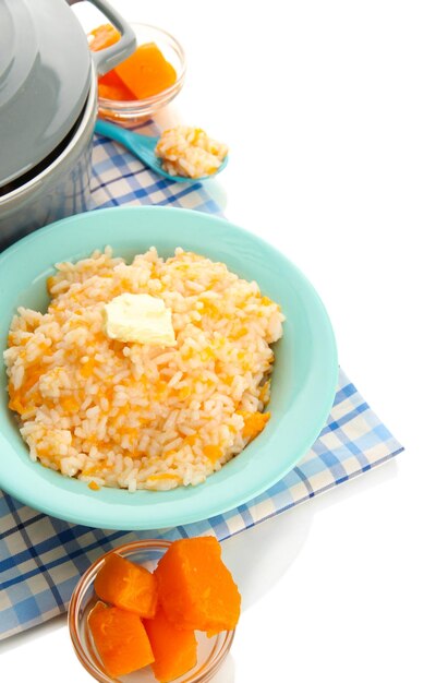 Taste rice porridge with pumpkin in blue bowl isolated on white