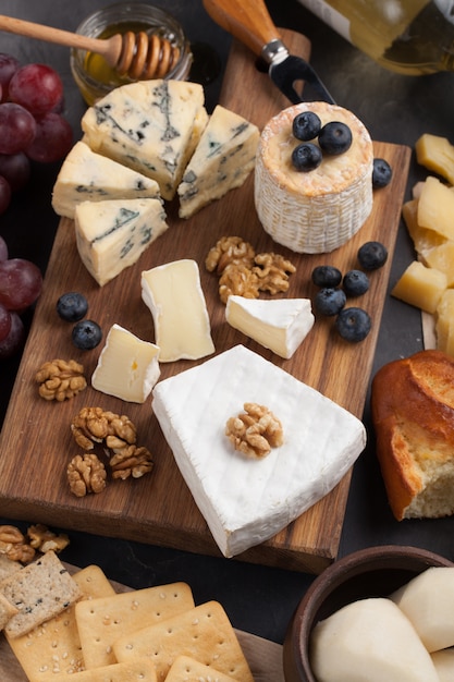 Tasting cheese dish on a dark stone plate.