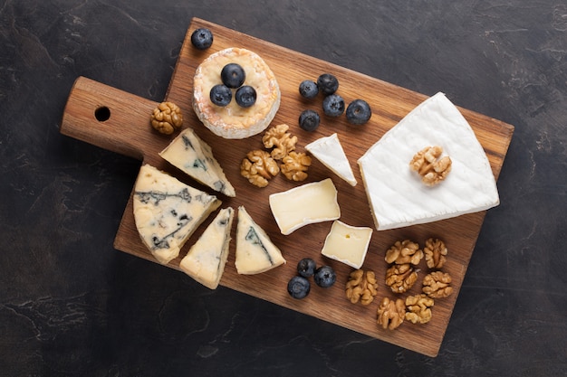 Tasting cheese dish on a dark stone plate.