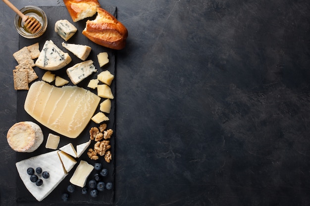 Tasting cheese dish on a dark stone plate.