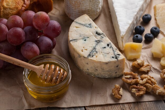 Tasting cheese dish on a wooden background.